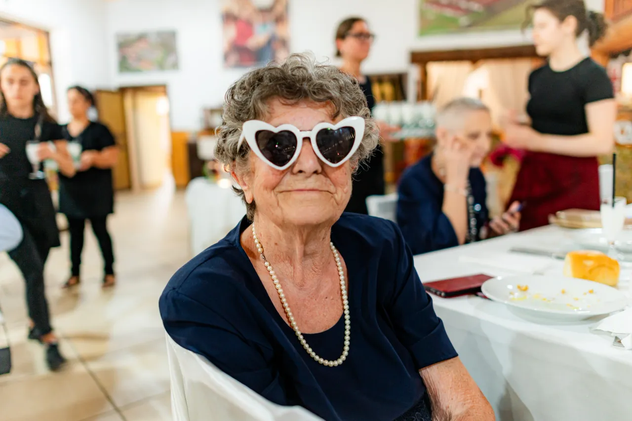 A guest wearing heart-shaped sunglasses