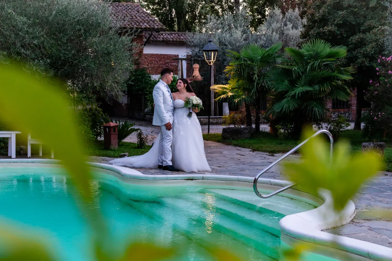 The couple in a garden beside a swimming pool