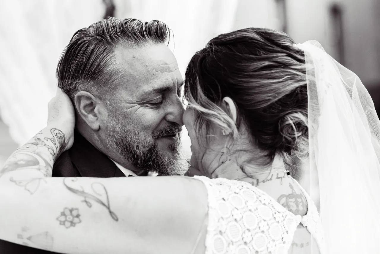 The couple embracing, in black and white