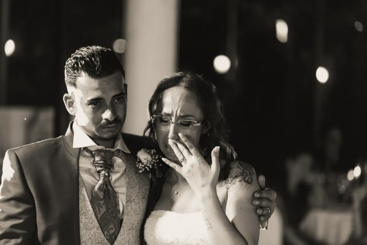 The bride wiping away a tear beside the groom