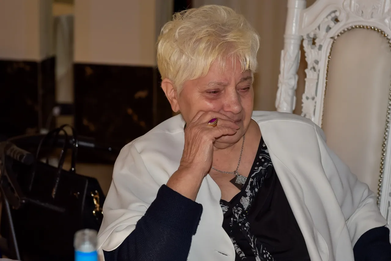 A tearful woman with a hand near her face