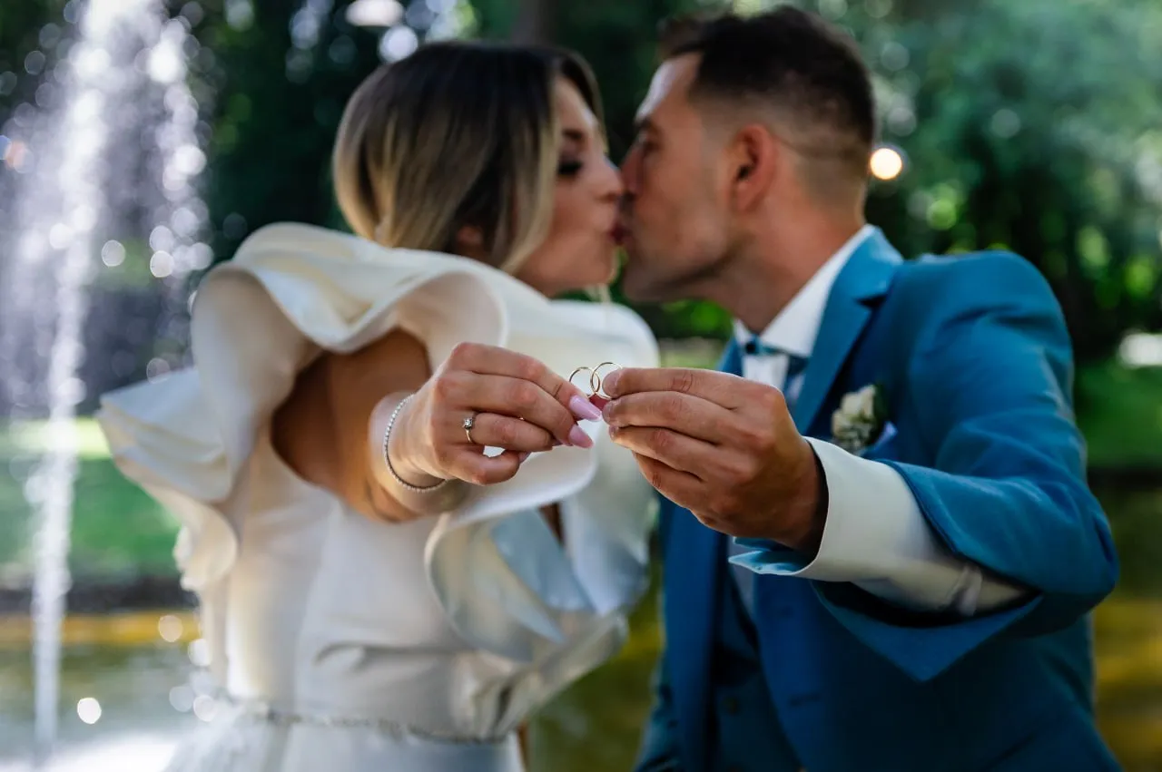 A couple with their wedding rings in the foreground