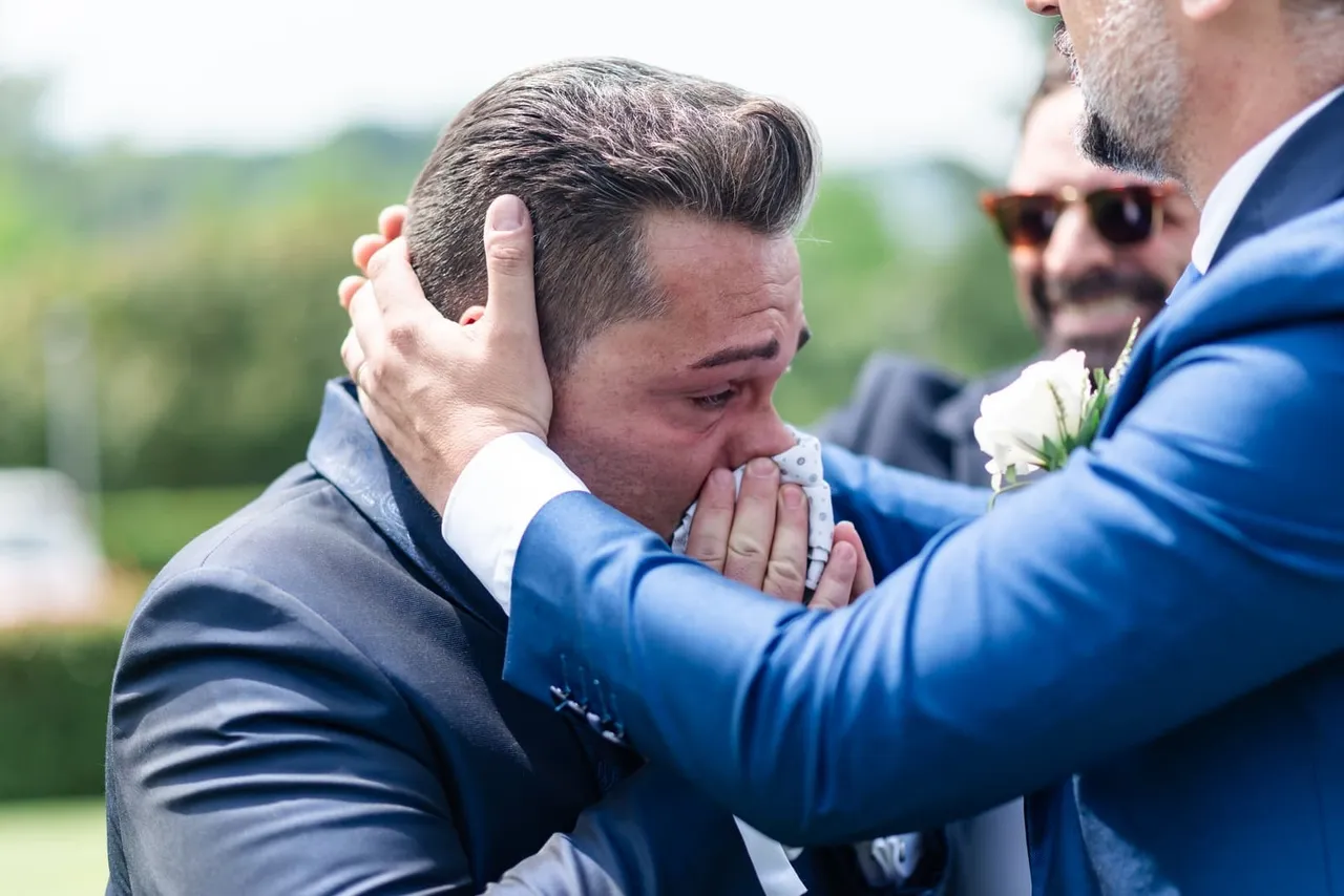 Davide overcome with emotion, holding a handkerchief to his face