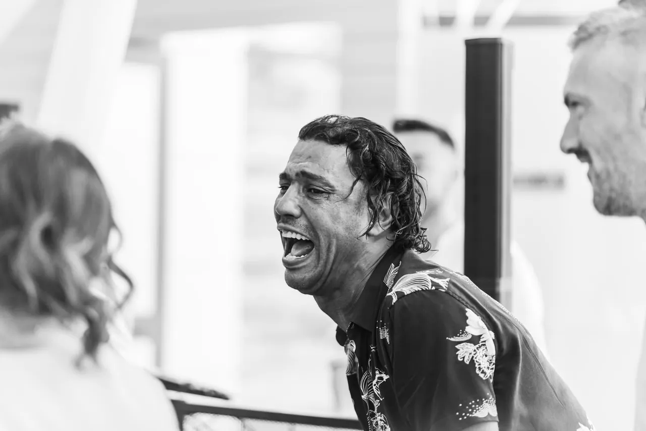 A guest laughing, in black and white