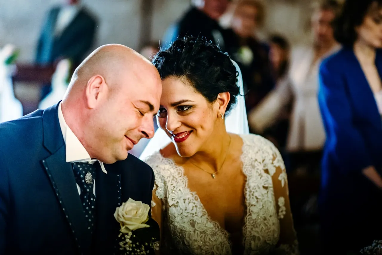 Valentina and Christian leaning their foreheads together, smiling