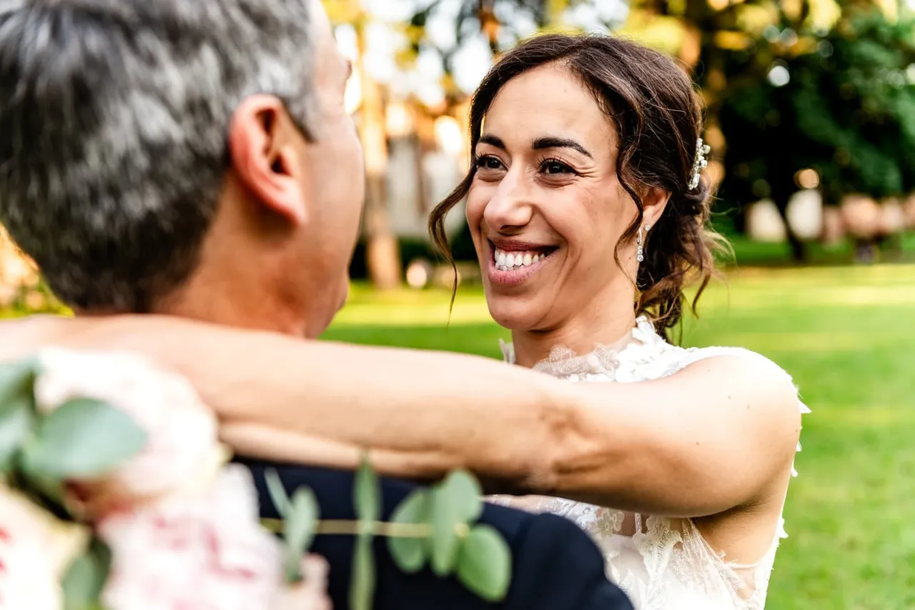 Veronica smiling as she embraces a man