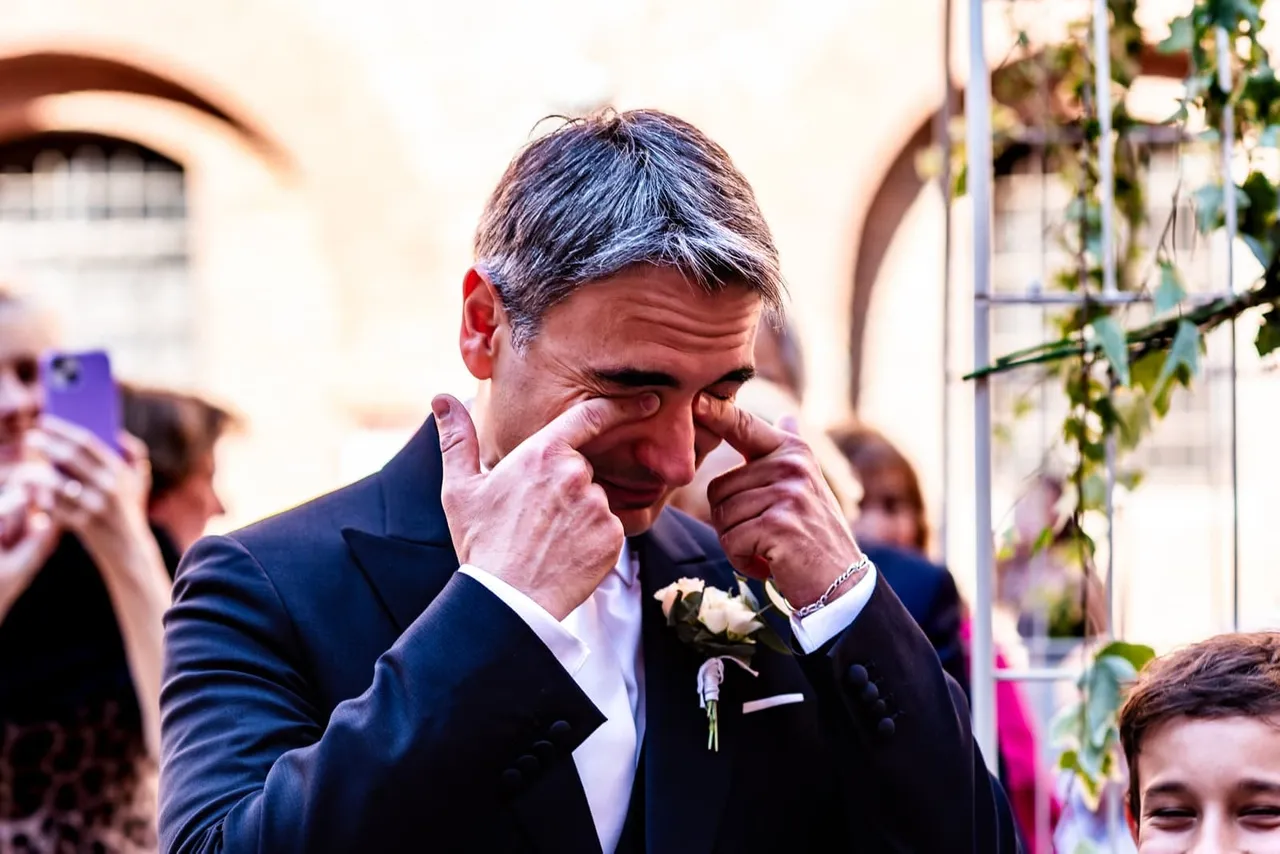 Carlo wiping away tears during the ceremony