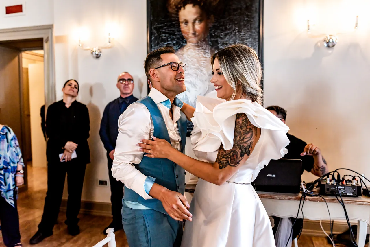 Nikla and Maurizio laughing as they dance together
