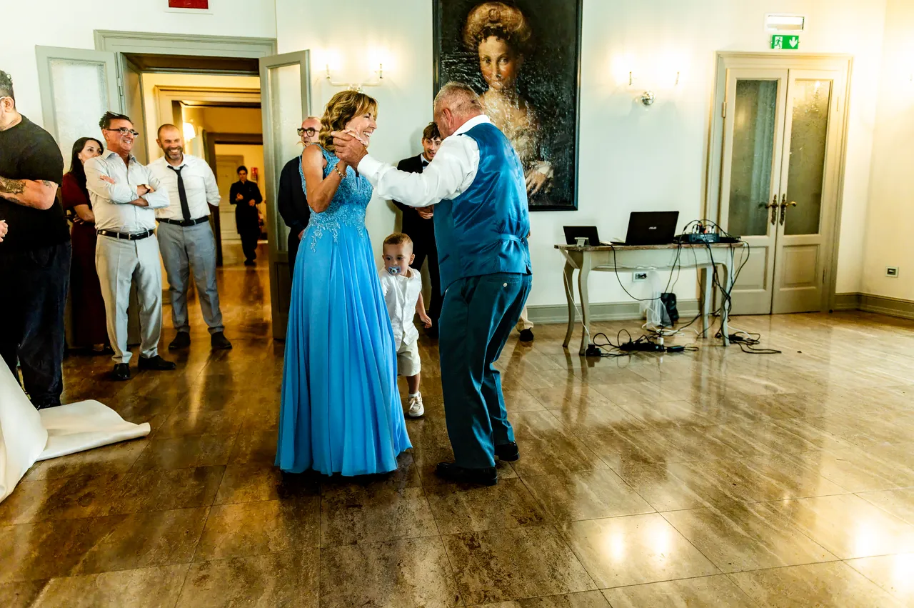Maurizio’s parents dancing together in the reception room