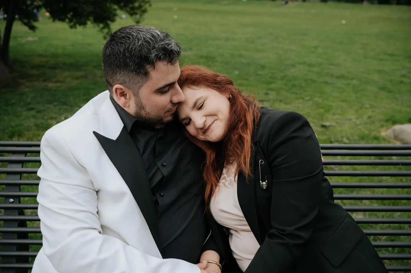 Simone and Jessica embracing on a bench